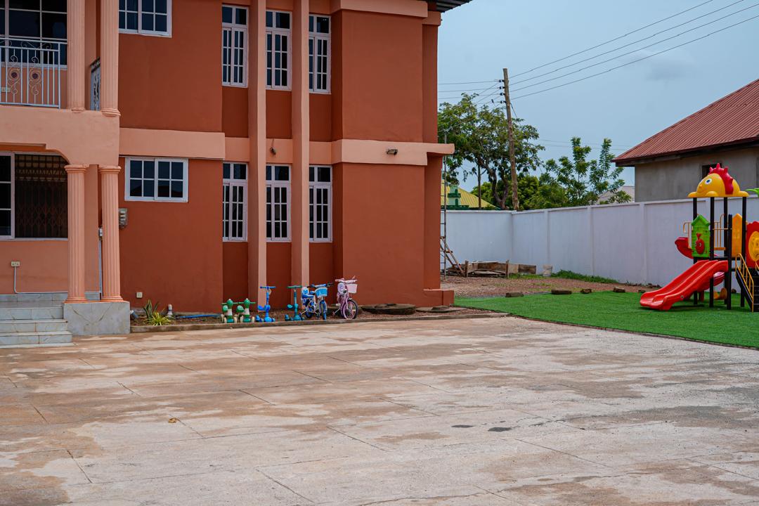 A calm campus setting with classroom blocks and outdoor play.