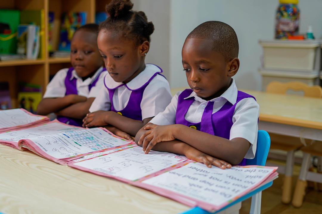 Learners building early literacy confidence with guided classwork.